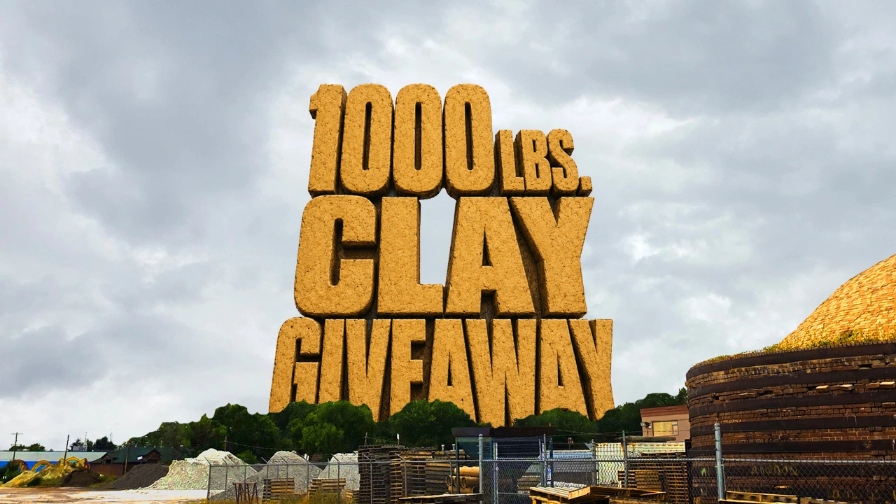 Large yellow sign reading "1000 lbs Clay Giveaway" displayed outdoors near piles of clay and construction materials under a cloudy sky.