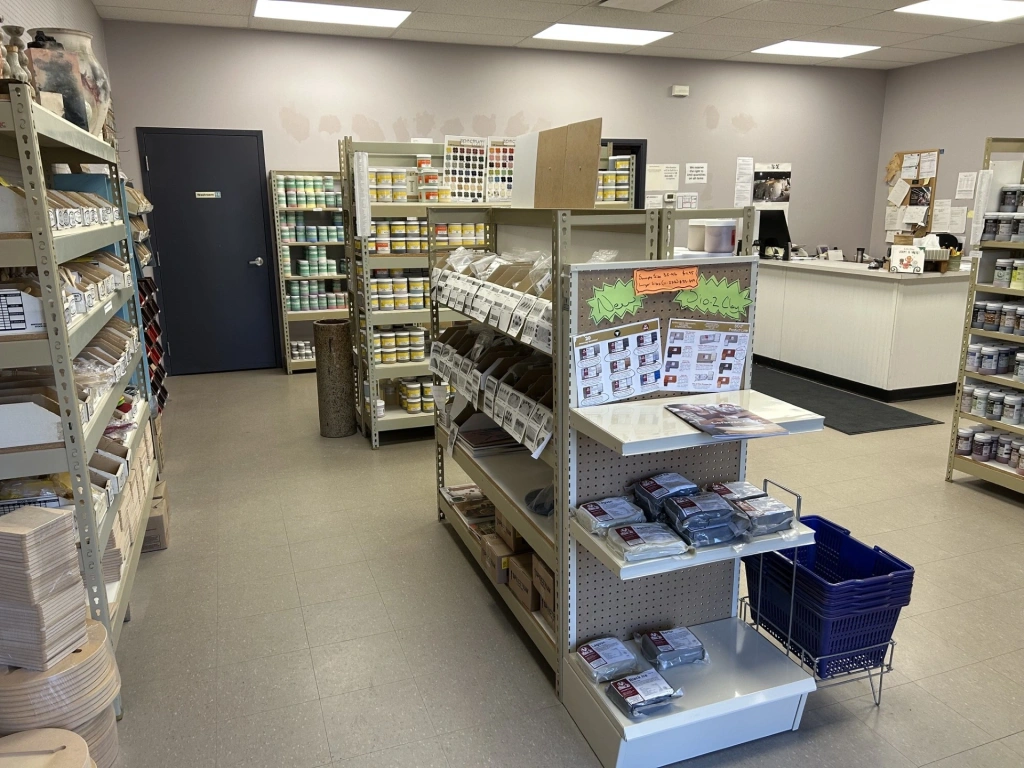 Interior view of a clean, well-organized pharmacy with shelves stocked with medication and health products.