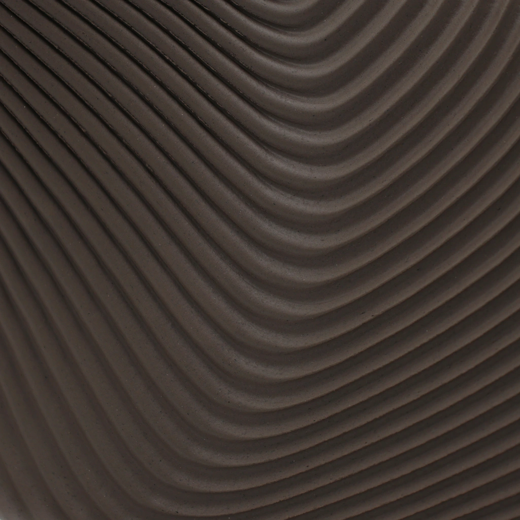 Dark brown surface with evenly spaced, curved, wave-like ridges creating a textured pattern.