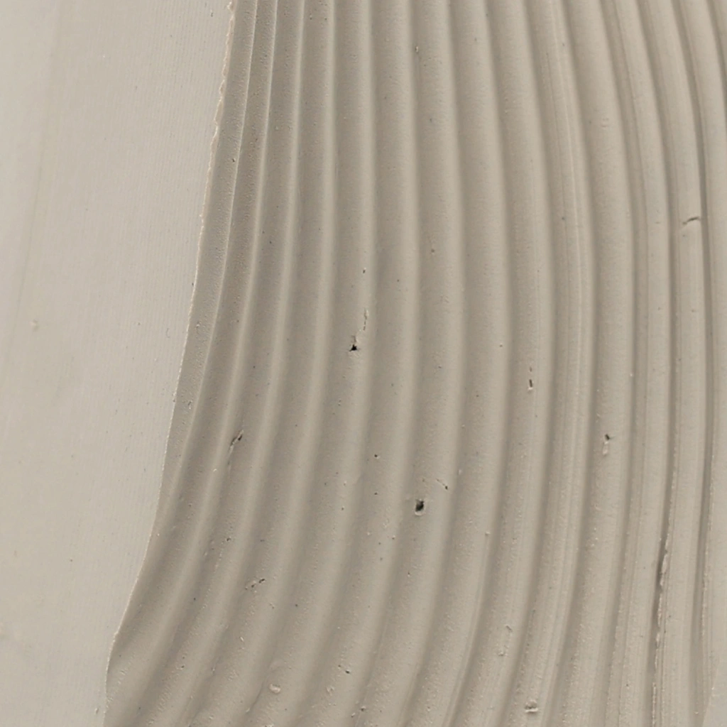 Close-up of beige textured fabric with evenly spaced vertical ridges and small scattered dark specks.