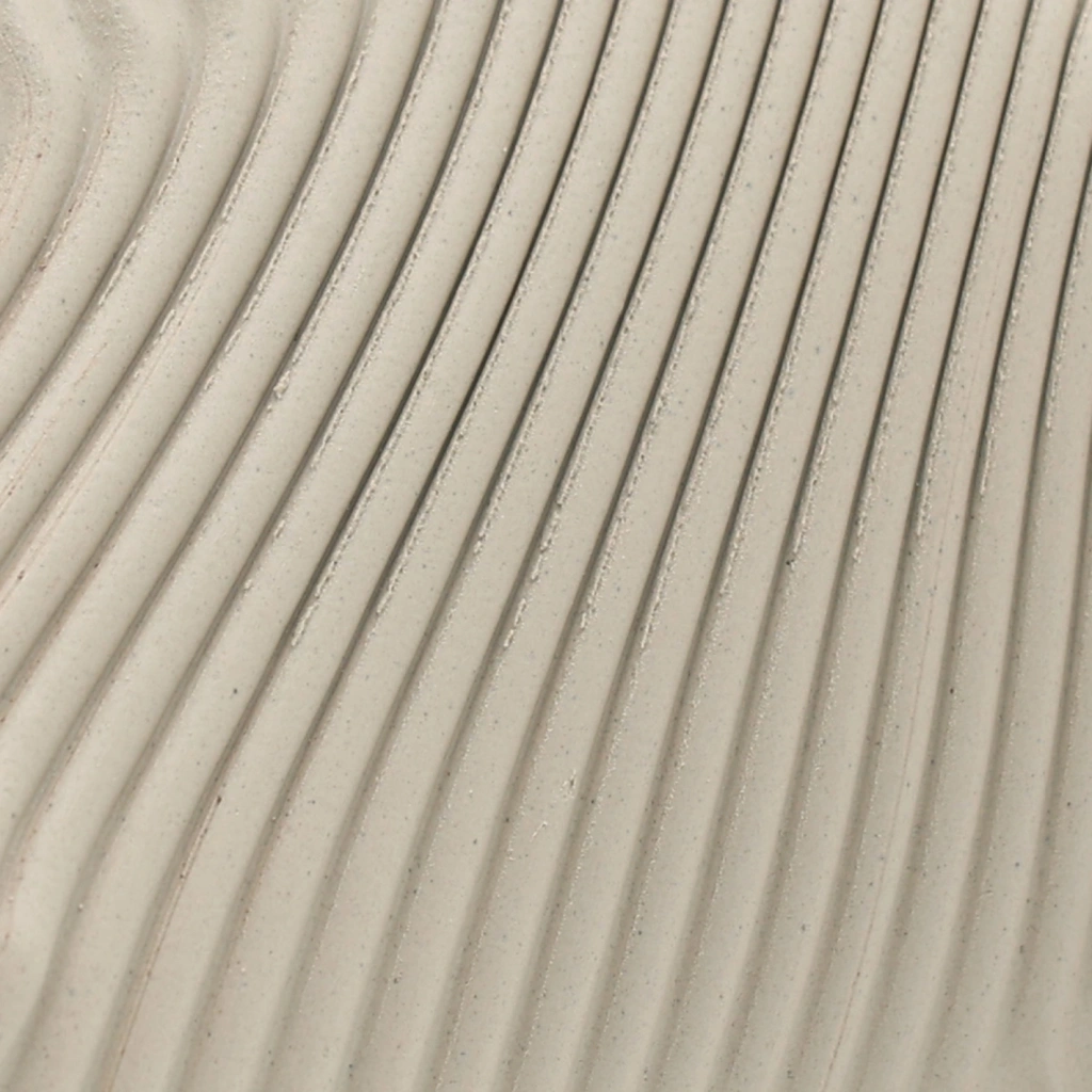 Close-up of beige fabric with evenly spaced, vertical pleats creating a textured pattern.