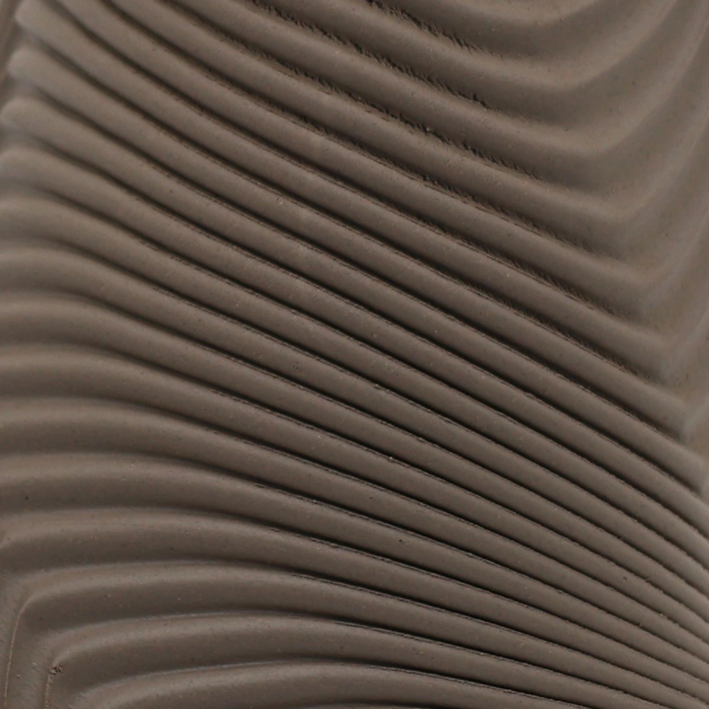 Close-up of smooth, curved, wave-like brown ridges creating an abstract, textured pattern.