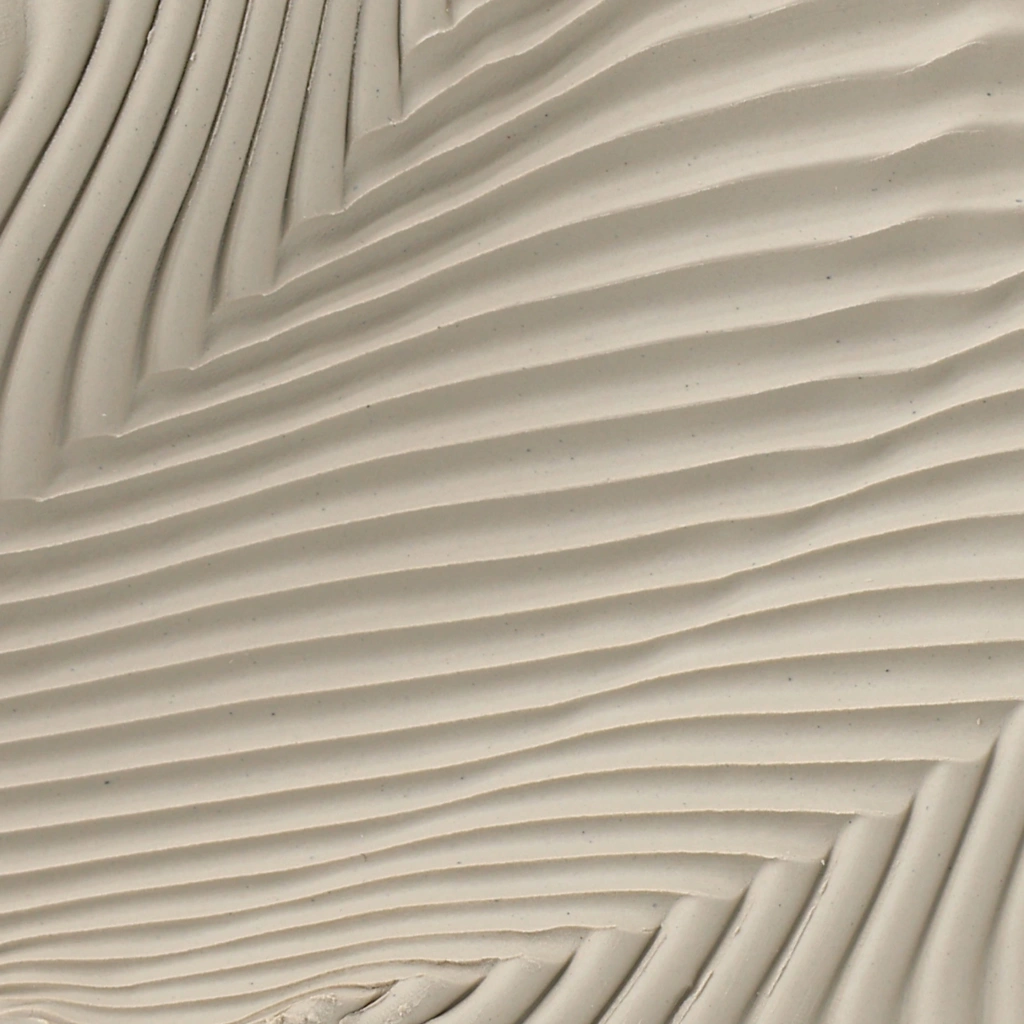 Close-up of a beige surface with flowing, wavy textured lines creating a modern, abstract pattern.
