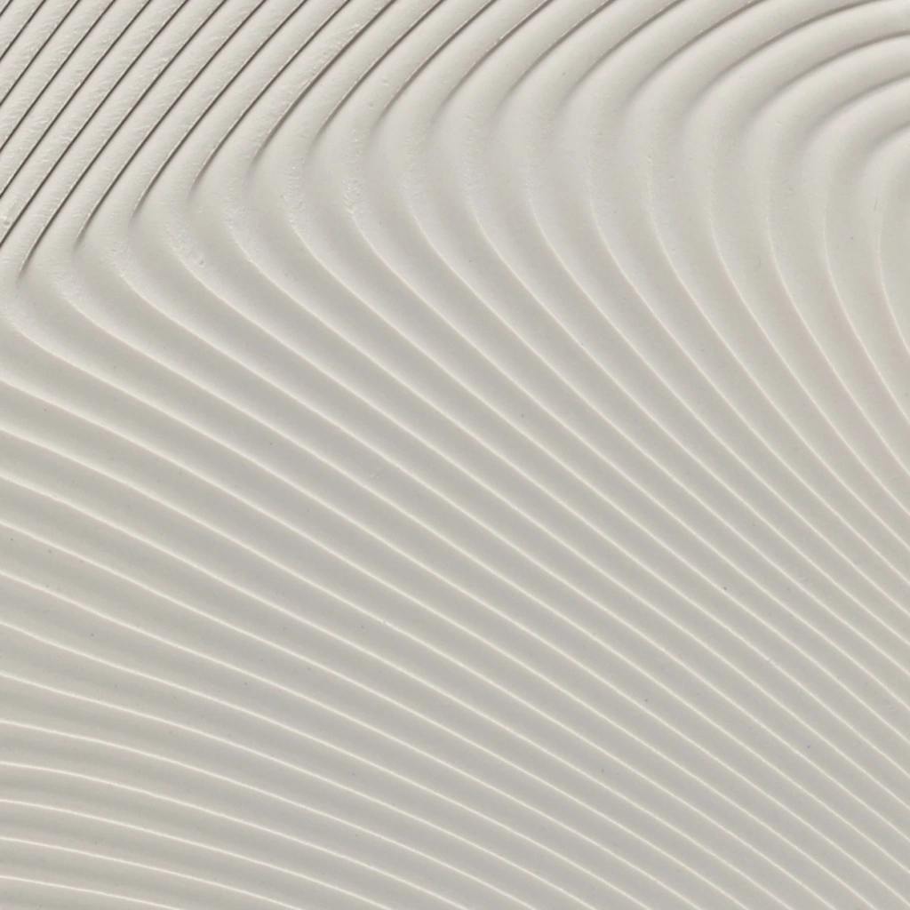 Abstract close-up of smooth, curved white ridges creating a flowing, wave-like pattern.