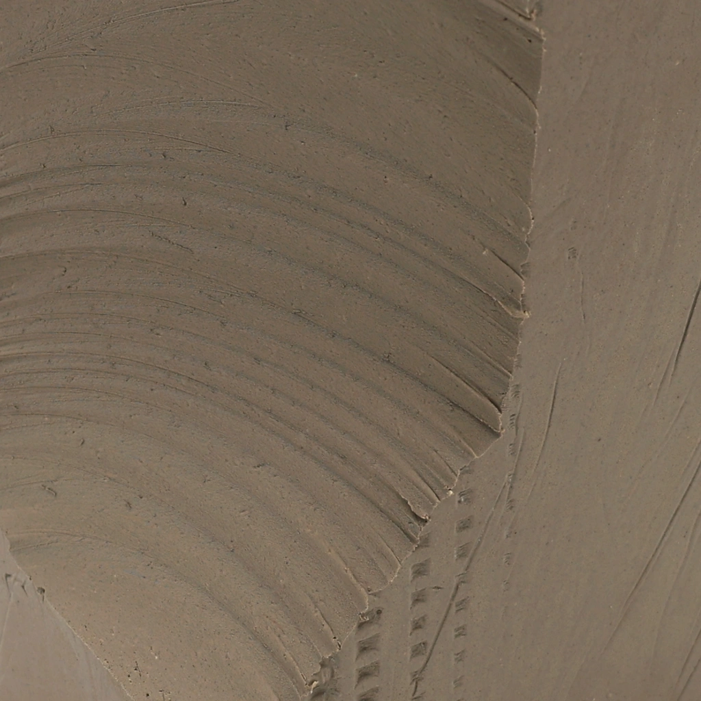 Close-up view of a smooth, curved concrete surface with visible seams and texture details.
