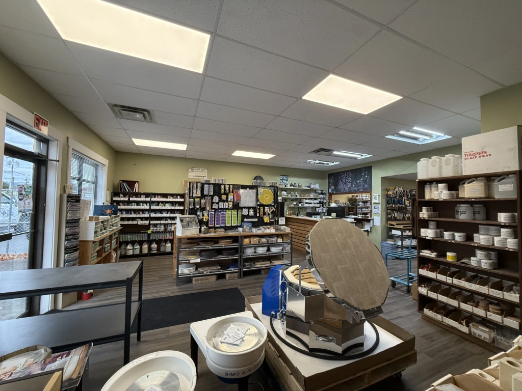 Interior view of a well-organized store with shelves stocked with various health and wellness products under bright fluorescent lighting.